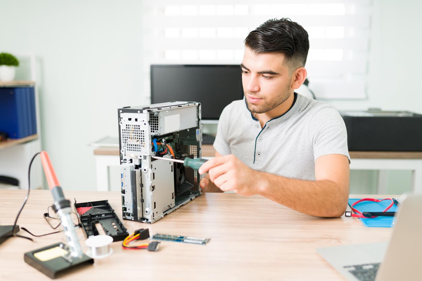 young male technician installing new components broken cpu customer latin man running repair shop 662251 21